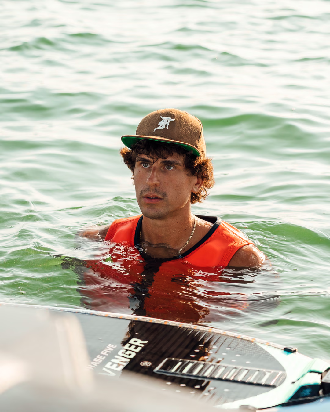 Alessio in the water next to his wakeboard