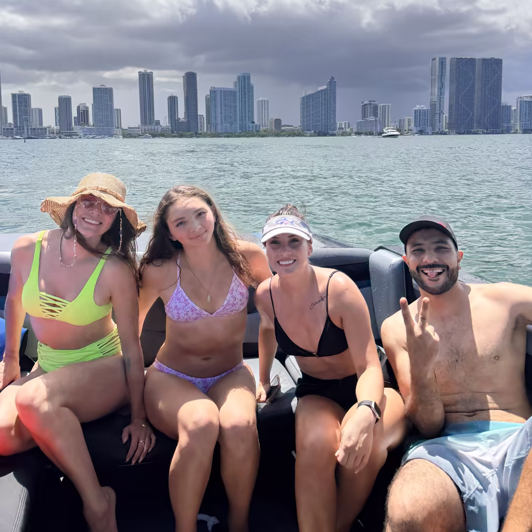 Four friends on the boat with the Miami skyline