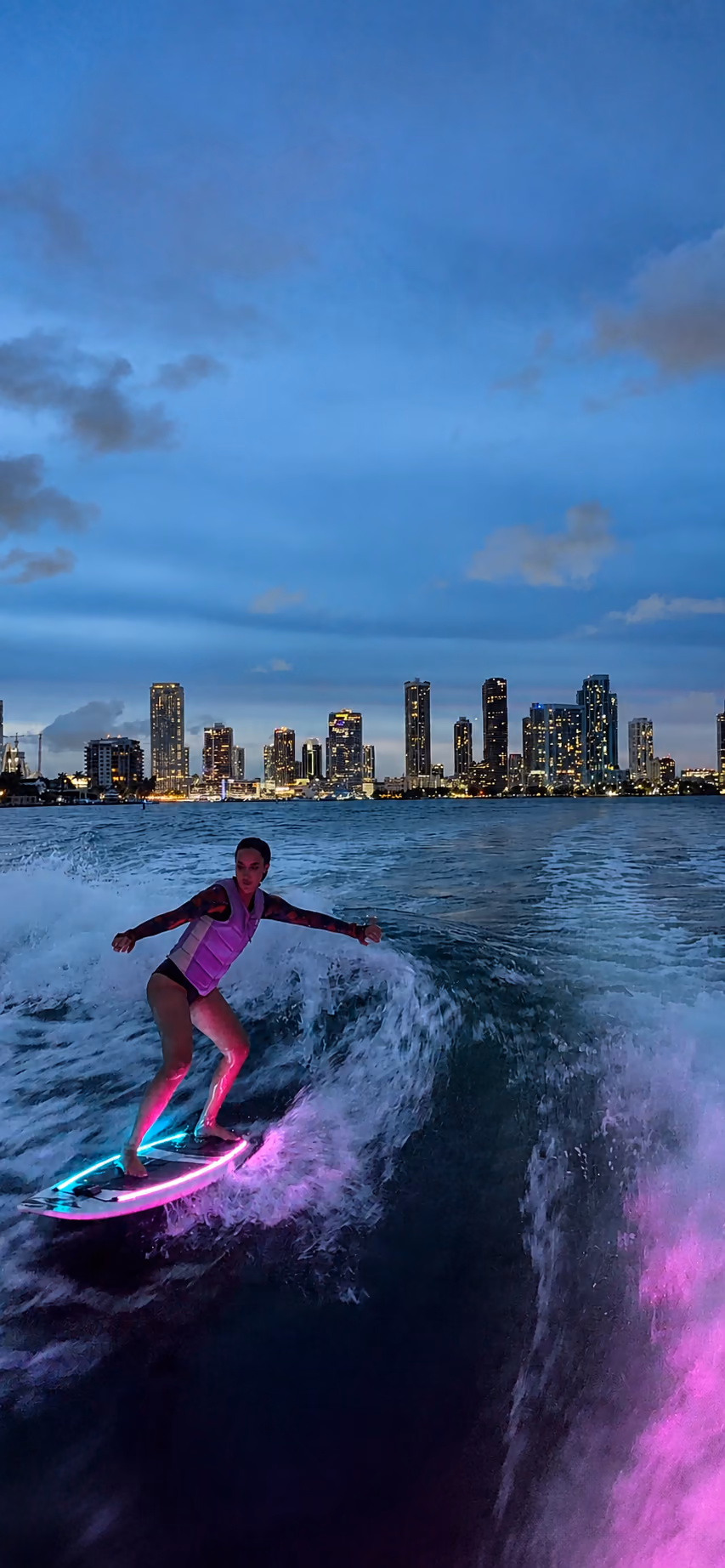 Night riding — the LED board lighting up the wake with Miami behind